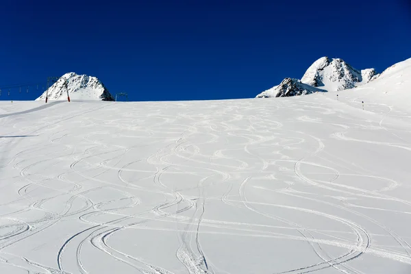 Fresh ski tracks on ski slope