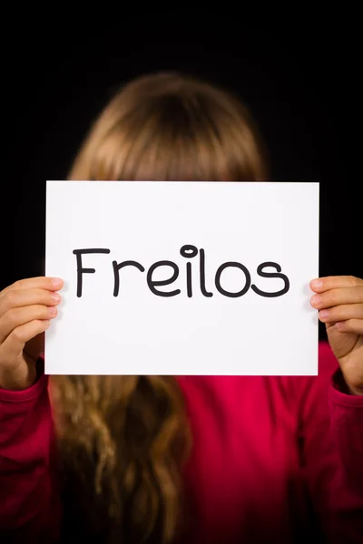 Child holding sign with German word Freilos - See You Later