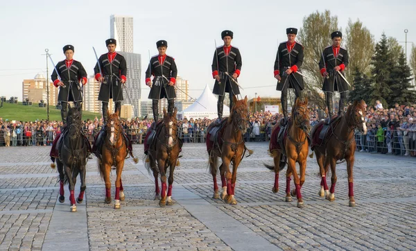 Moscow, Russia - May 8, 2015: Horsemen Cavalry Escort of the Presidential Regiment perform trick riding. Horse show on Poklonnaya Gora