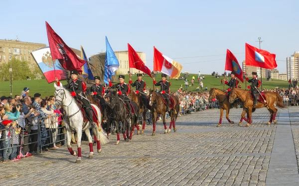 Moscow, Russia - May 8, 2015: Horsemen of the Kremlin Riding School with the flags of the hero-cities, horse show on Poklonnaya Gora