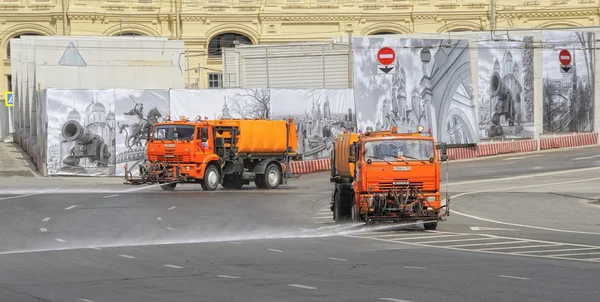 Moscow, Russia - May 3, 2014: Watering machine orange color washes the streets of Moscow, utilities