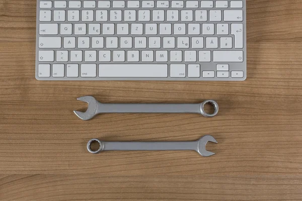 Keyboard and wrenches on Desktop