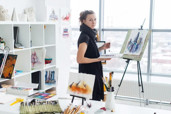 Female painter drawing in art studio