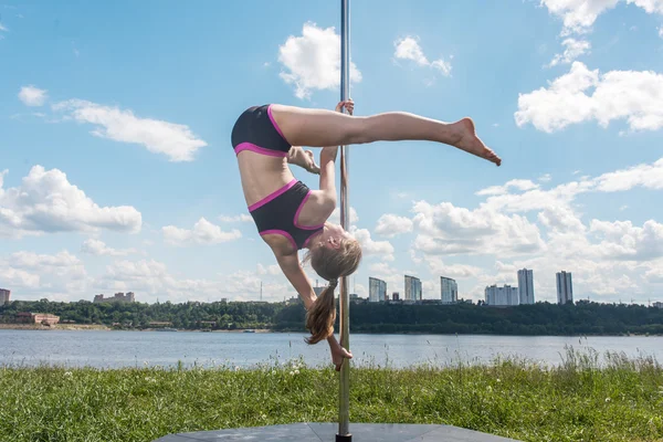 Woman exercising with pylon outdoors