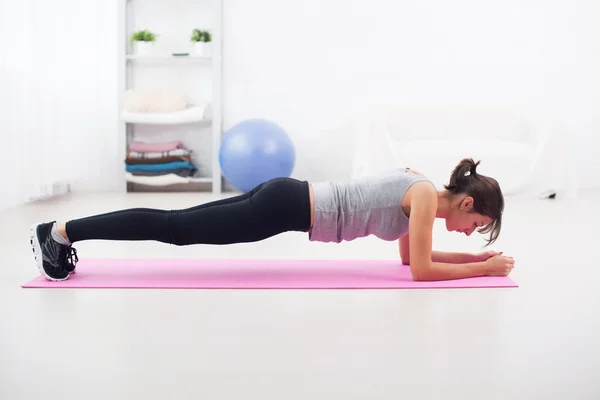 Fit girl in plank position