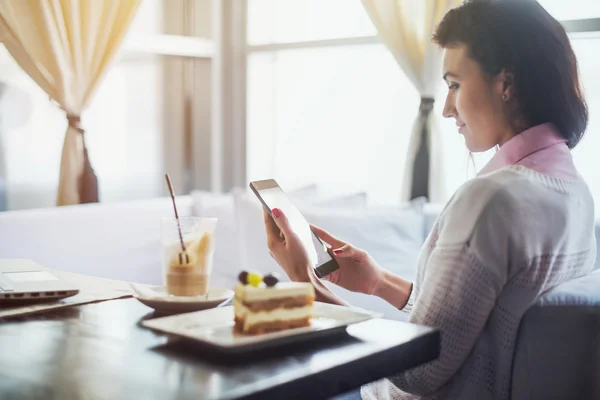 Woman in a restaurant holding digital tablet