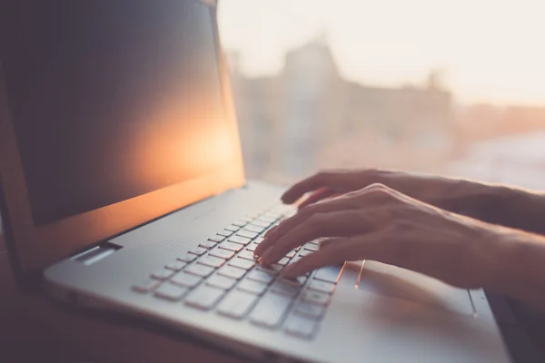 Woman typing on laptop