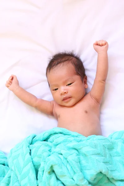 Newborn baby of asia relax in a good mood on white bed.