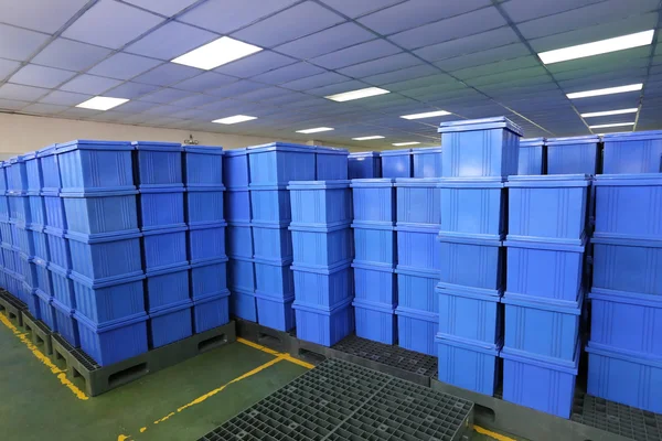Blue Plastic box products in Industrial factory room.