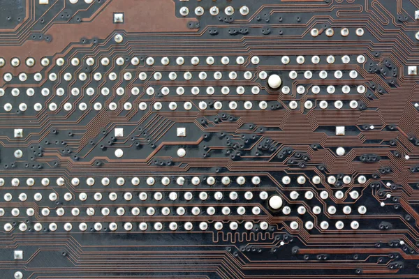 Brown electronics background of computer mainboard.