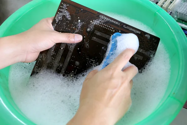 Cleaning computer motherboard.