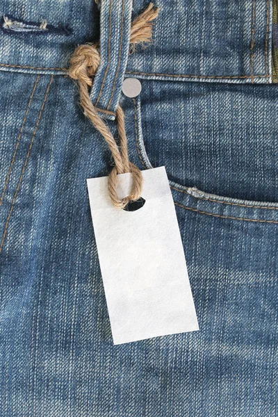 White paper label with hemp rope tied on denim or jeans.