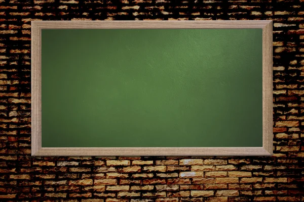 Blank old school blackboard on a grunge wall and can input text