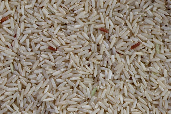 Pile of organic brown rice for the nature food background.