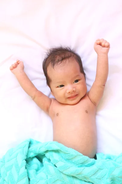 Newborn baby of asia relax in a good mood on white bed.