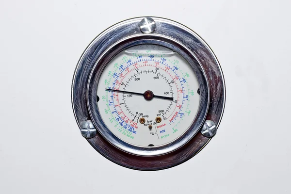 Closeup of a pressure meter on a refrigerator machine