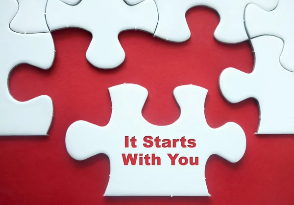 Puzzle pieces over red background with motivational quote \