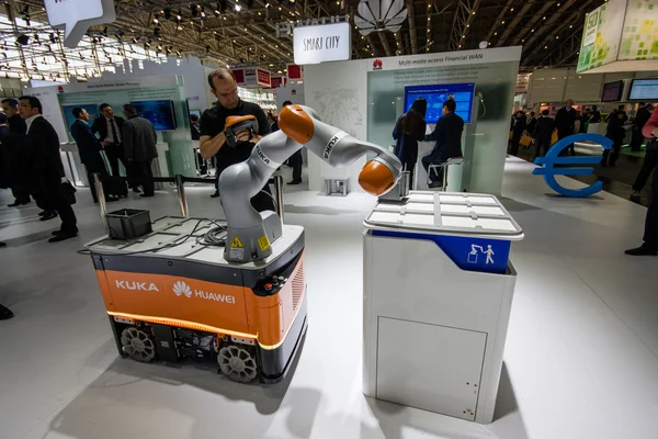 HANNOVER, GERMANY - MARCH 14, 2016: Industrial KUKA robot in booth of Huawei company at CeBIT information technology trade show in Hannover, Germany on March 14, 2016