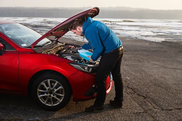 Man filling antifreeze fluid in his car