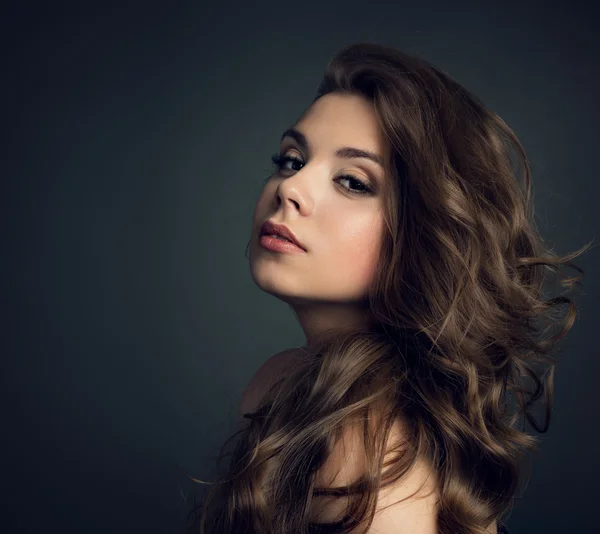 Portrait of a young beautiful brunette girl with long  hair