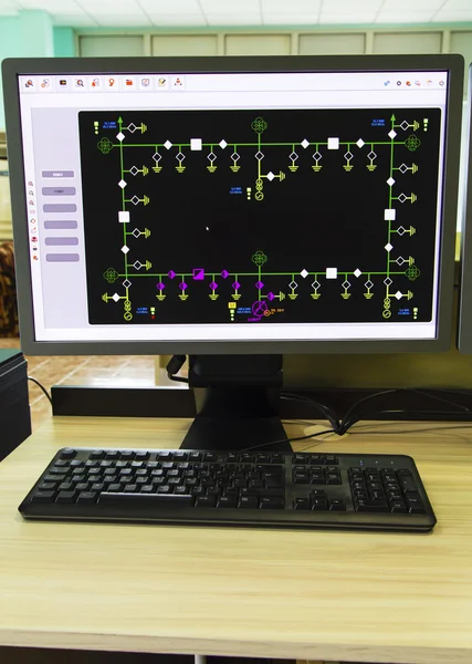 Computers and monitors with schematic diagram for supervisory, control and data acquisition