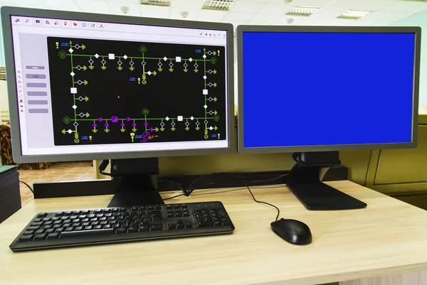 Computers and monitors with schematic diagram for supervisory, control and data acquisition