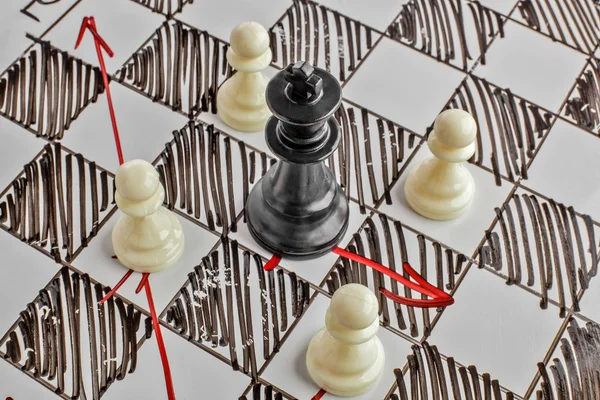 Chess. The black King is under attack. White board with chess figures on it. Helpmate or checkmate.