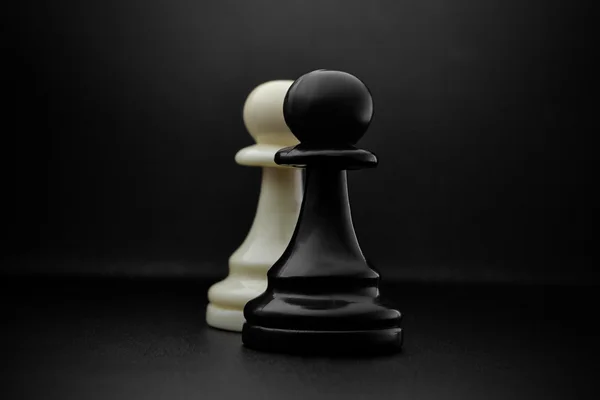 Chess. Black and White pawns on the black background. Pawns, infantry chess.