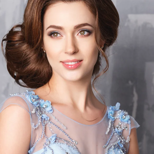 Close-up portrait of beautiful young woman in luxury dress, pastel color. Beauty fashion portrait