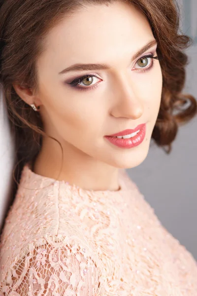 Close-up portrait of beautiful young woman in luxury dress, pastel color. Beauty fashion portrait
