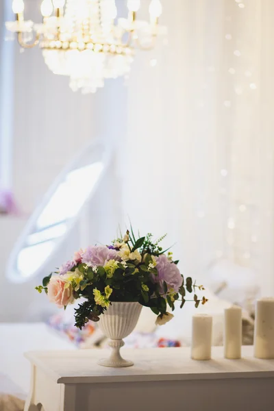 Tender interior with flower bouquet in a morning. Shabby style in a bedroom