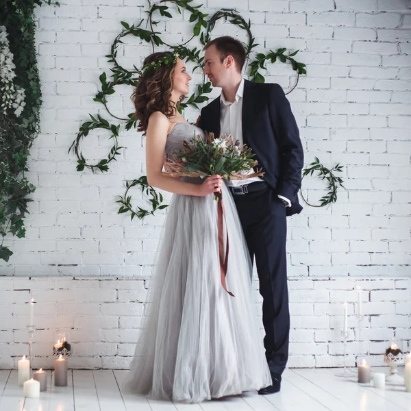 Bride and groom in elegant grey and green style over ecological natural decoration