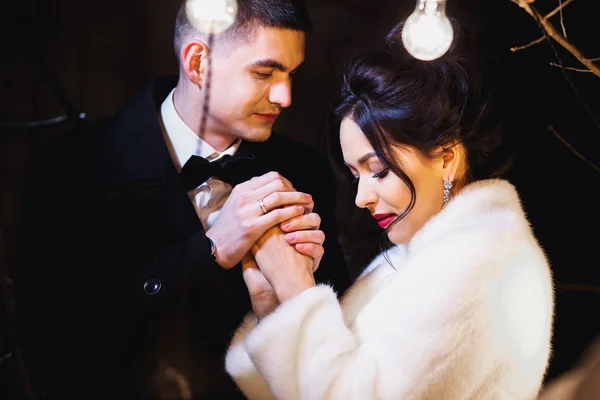 Wedding couple bride and groom together in a winter street decoration