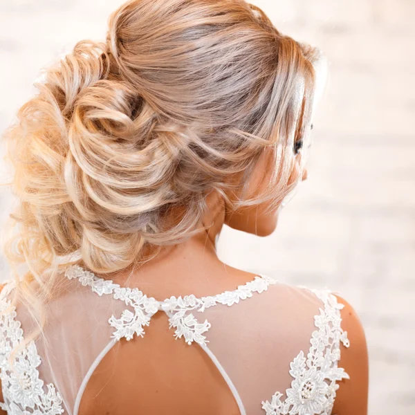 Gorgeous elegant bride in luxury wedding dress in a white loft space