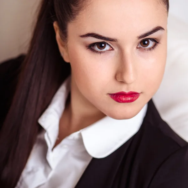 Portrait of Young business woman in a suit with perfect makeup and hair style