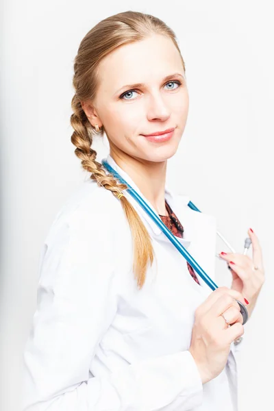 Portrait of an elegant doctor woman in medical gown on white background isolated