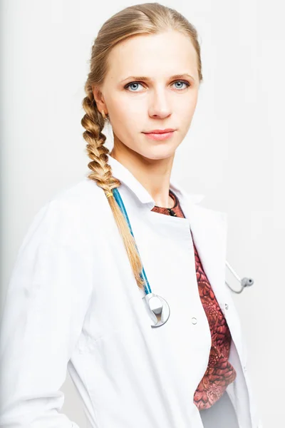 Portrait of an elegant doctor woman in medical gown on white background isolated