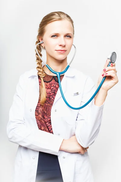 Portrait of an elegant doctor woman in medical gown on white background isolated