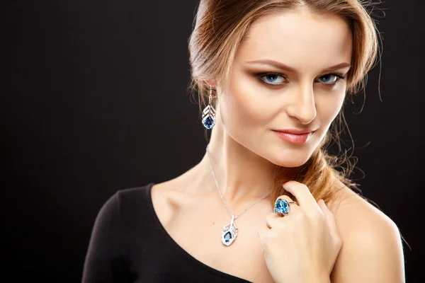 Close-up portrait of beautiful young woman with luxury jewelry and perfect make up. Fashion beauty portrait