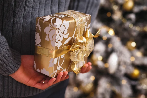 Close up photo of male hands holding a gift