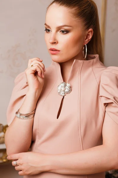 Close-up portrait of beautiful young woman with luxury jewelry and perfect make up. Fashion beauty portrait
