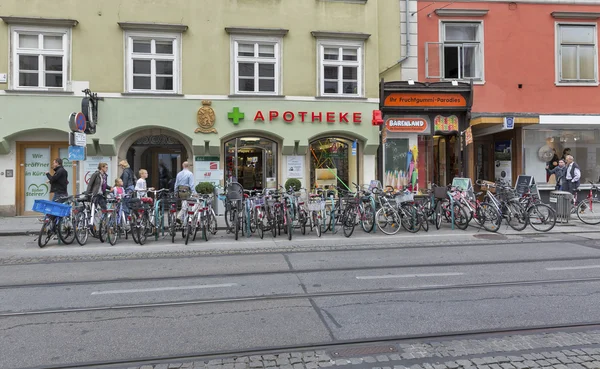 Street bicycle parking and pharmacy in Graz, Austria.
