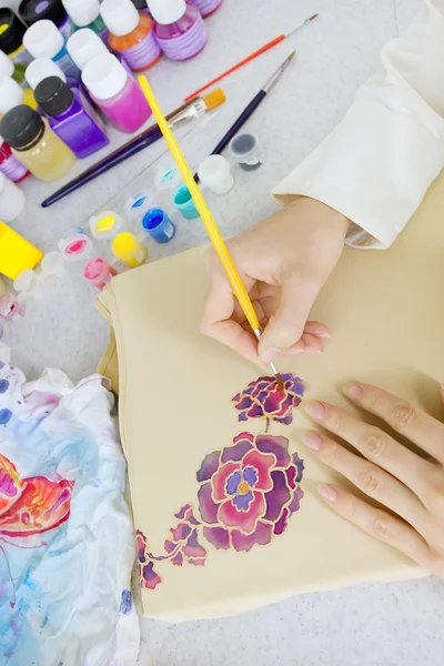 Batik process: artist paints on fabric, Batik painting