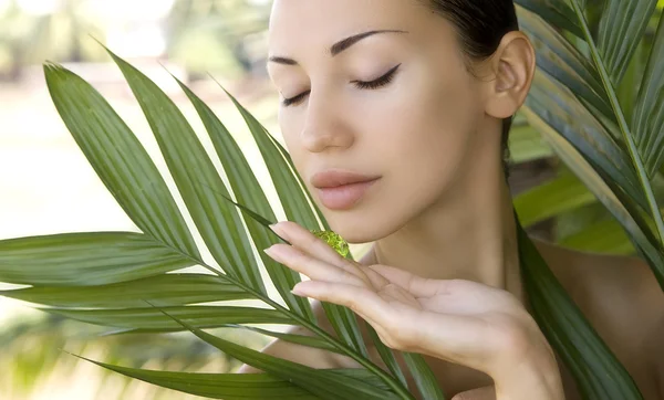 Beautiful woman holding aloe vera gel, skin care and wellness. F