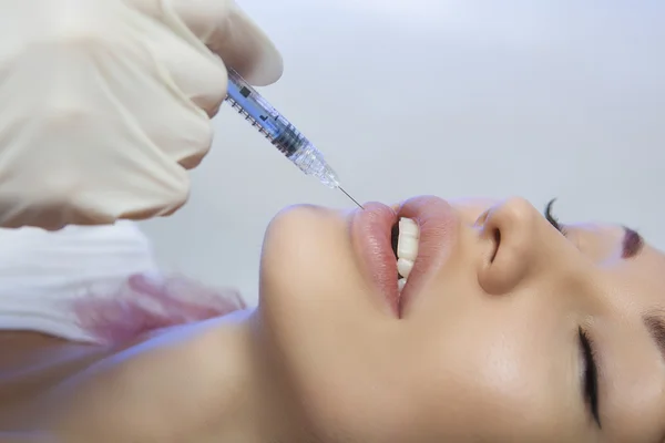 Woman Gets an Injection in her Lips in Beauty Salon