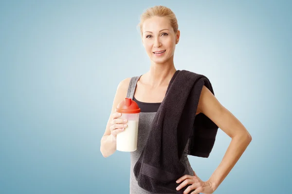 Woman  holding protein shaker bottle