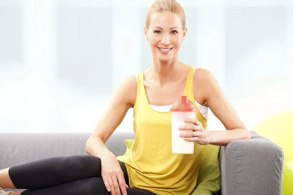 Woman holding protein shaker
