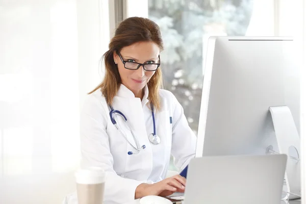 Female specialist doctor working on computer