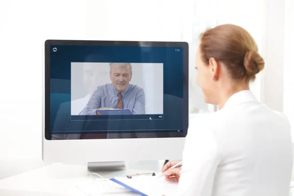 Assistant having video chat with executive businessman