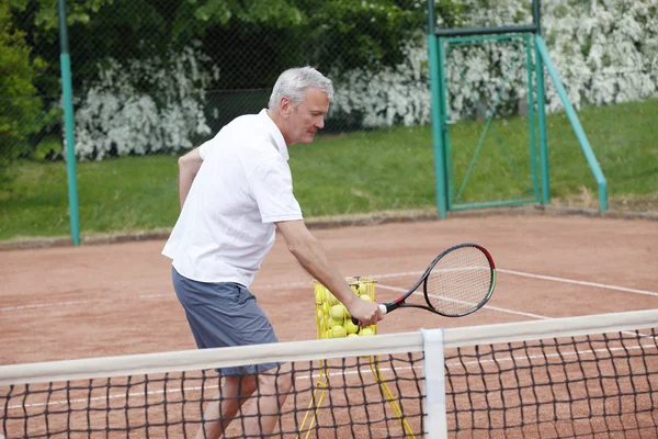 Tennis coach playing tennis